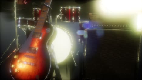 drum kit and guitar in subdued stage lighting.