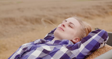 successful female farmer relaxing at farm