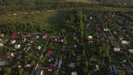 flying over village houses and moving cargo train