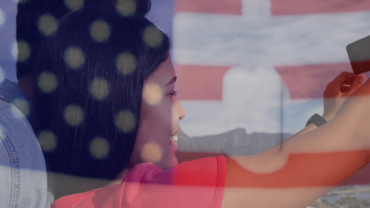 Taking selfie, woman with American flag overlay and military dog tags