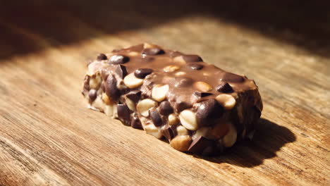 chocolate bar with nuts on wooden surface