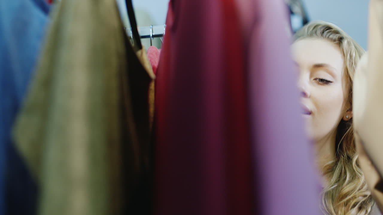 Young Woman Chooses A Dress In A Store 2