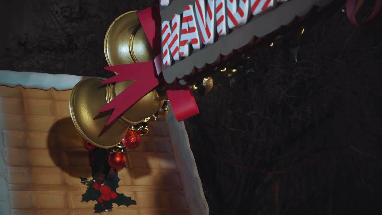 Christmas bells with lights at night. Christmas bells with the red ribbon