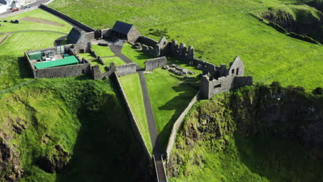 aerial birdseye shot of ruins of the medieval dunluce castle in ireland