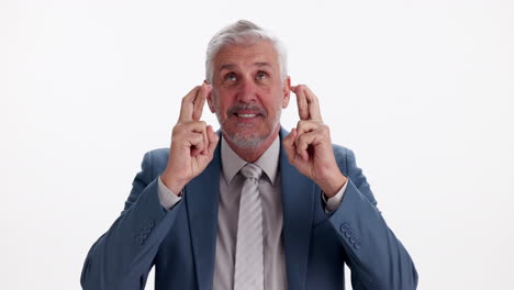 senior man with fingers crossed