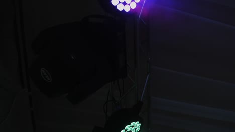 stage lighting equipment. spotlights turning and sparkling. automated luminaire hang under hall ceiling and rotate in dark interior.