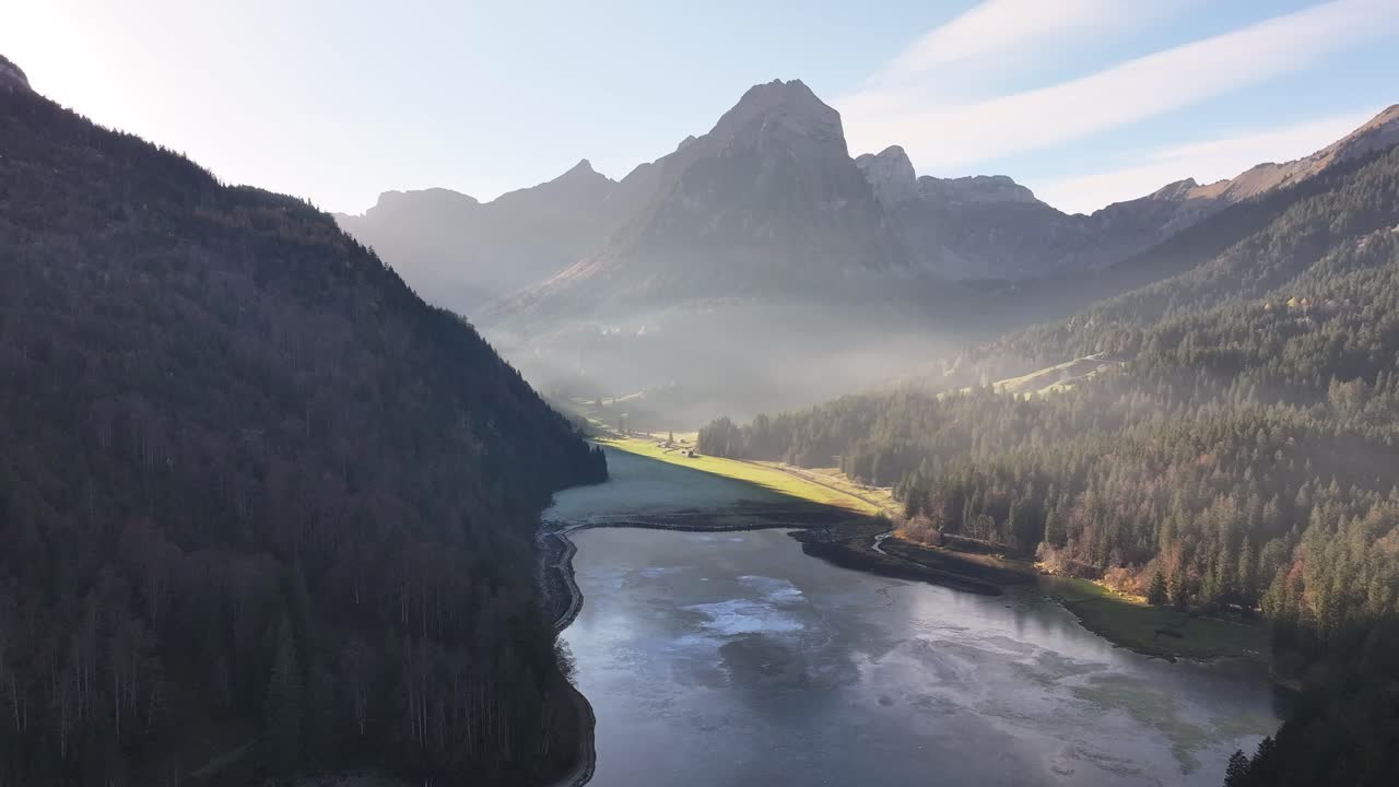 aerial - Obersee lake with Swiss Alps reflection, Glarus valley misty landscape