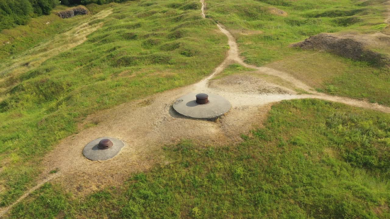 Two casemates from the fort of Douaumont in the middle of the countryside and green forests towards Verdun, in the Meuse, in Lorraine in the Great East of France, in summer and by drone.