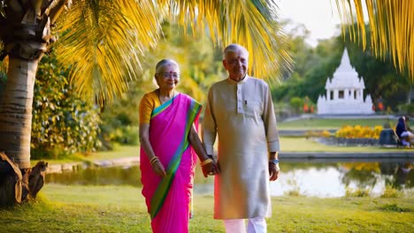 elderly indian couple walking in a garden