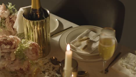 table set for meal at wedding reception with champagne in ice bucket 3