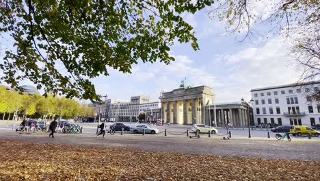 autumn scenery in berlin with foliage in front of brandenburg gate