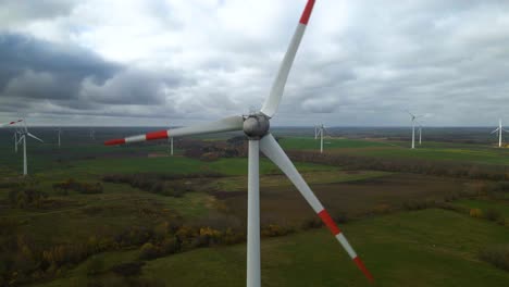 toma aérea de múltiples molinos de viento giratorios para la producción de energía eléctrica renovable en una amplia zona rural