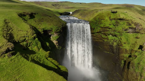 Skogafoss-waterfall-in-Iceland-summer-day-aerial-shot-summer-day-green-grass