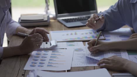 close-up of a financial analyst and a planning team of young entrepreneurs discussing project ideas using papers to brainstorm modern business firms.