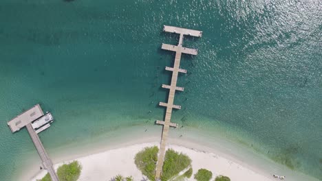 aerial topdown view of tropical dock and boats anchored in water, peanut island, florida