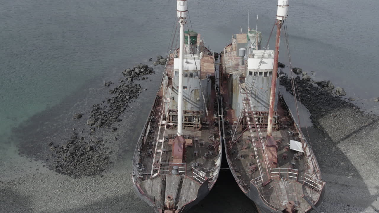 Fantastic reverse aerial shot of the abandoned whalers located in Hvalfj&ouml;r&eth;ur