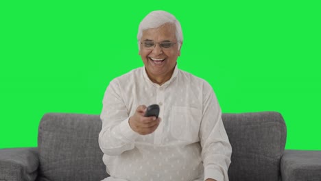 Happy-Indian-old-man-watching-TV-Green-screen