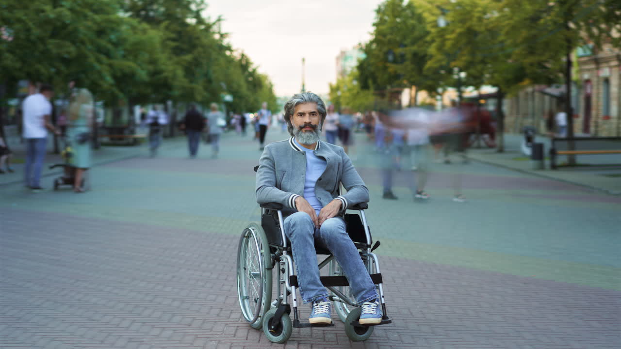 hombre en silla de ruedas en la calle de la ciudad