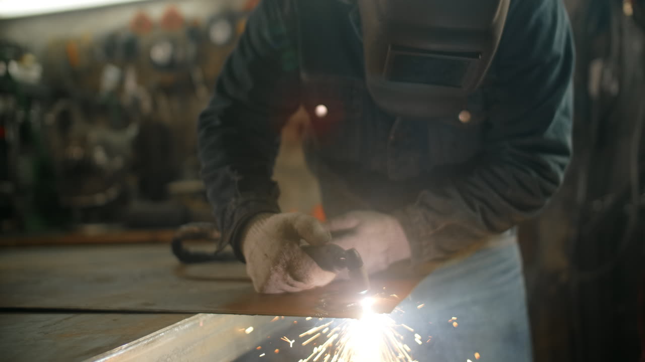 Welder Working on Metal Sheet