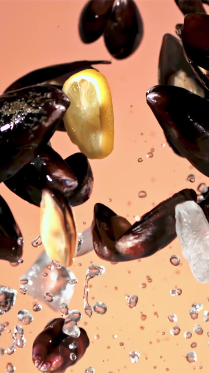 Fresh Mussels, Lemon, and Ice Splashing in Water in Slow Motion