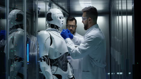 scientists working on a robot in a server room