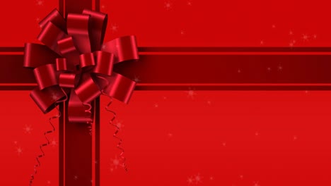 animation of snow falling over ribbon on red background