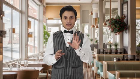 Indian-waiter-talking-to-the-camera