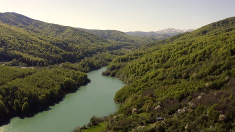 slow flyover above narrow lake formed by maneciu dam, romania