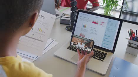 African-american-businesswoman-using-smartphone-for-video-call-with-business-colleague