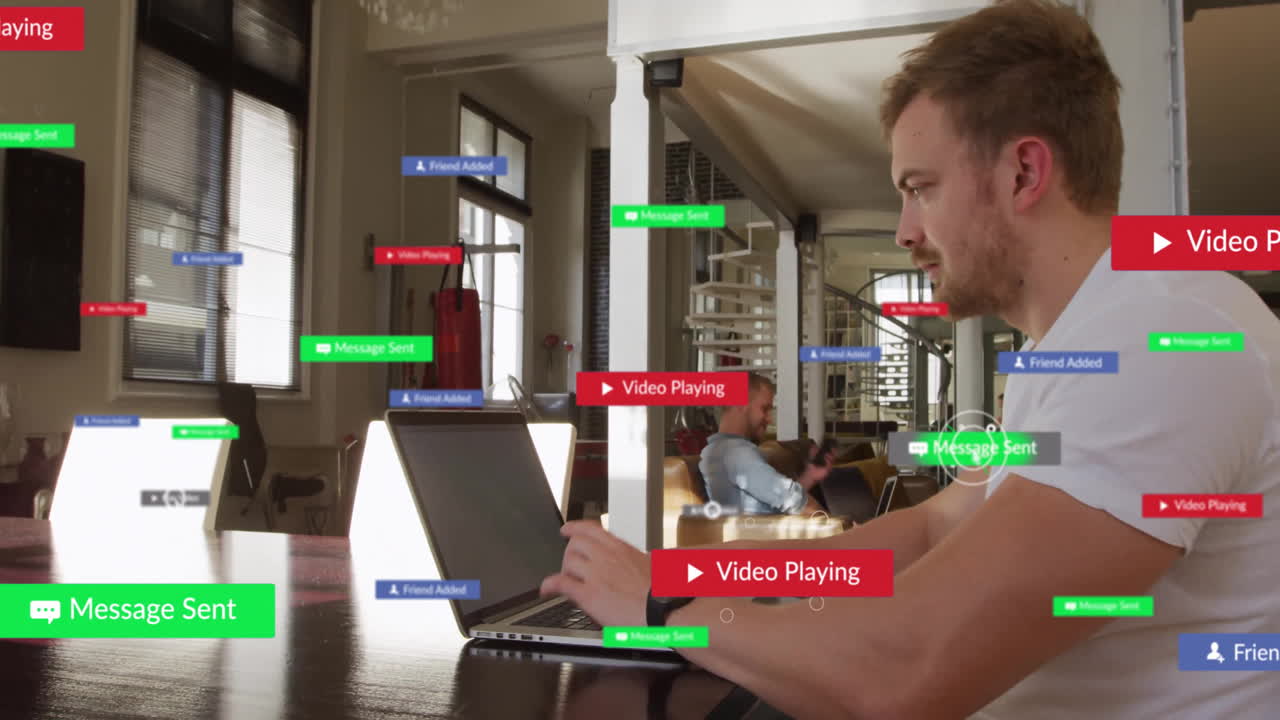 Technology team typing on laptop in coworking space, displaying floating social media UI labels