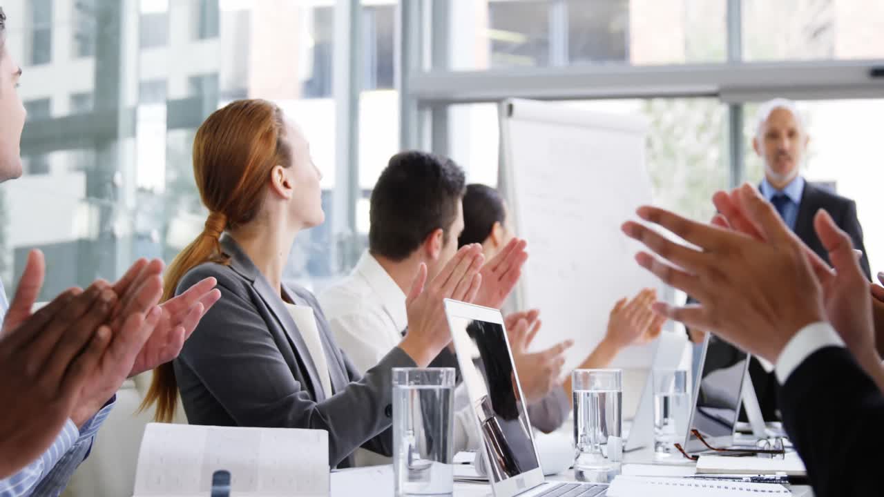 Business people applauding during a meeting