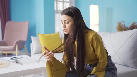 Stressed-young-woman-at-home-alone-thoughtful-and-agitated.