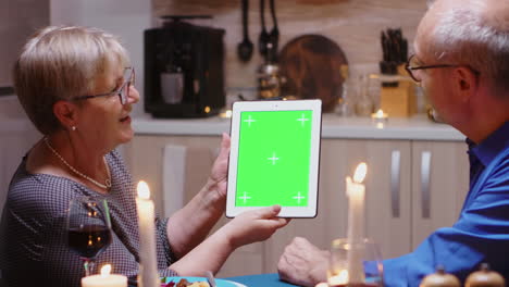 una pareja vieja con una tableta de pantalla verde.