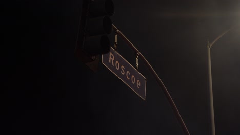 roscoe street sign - city at night