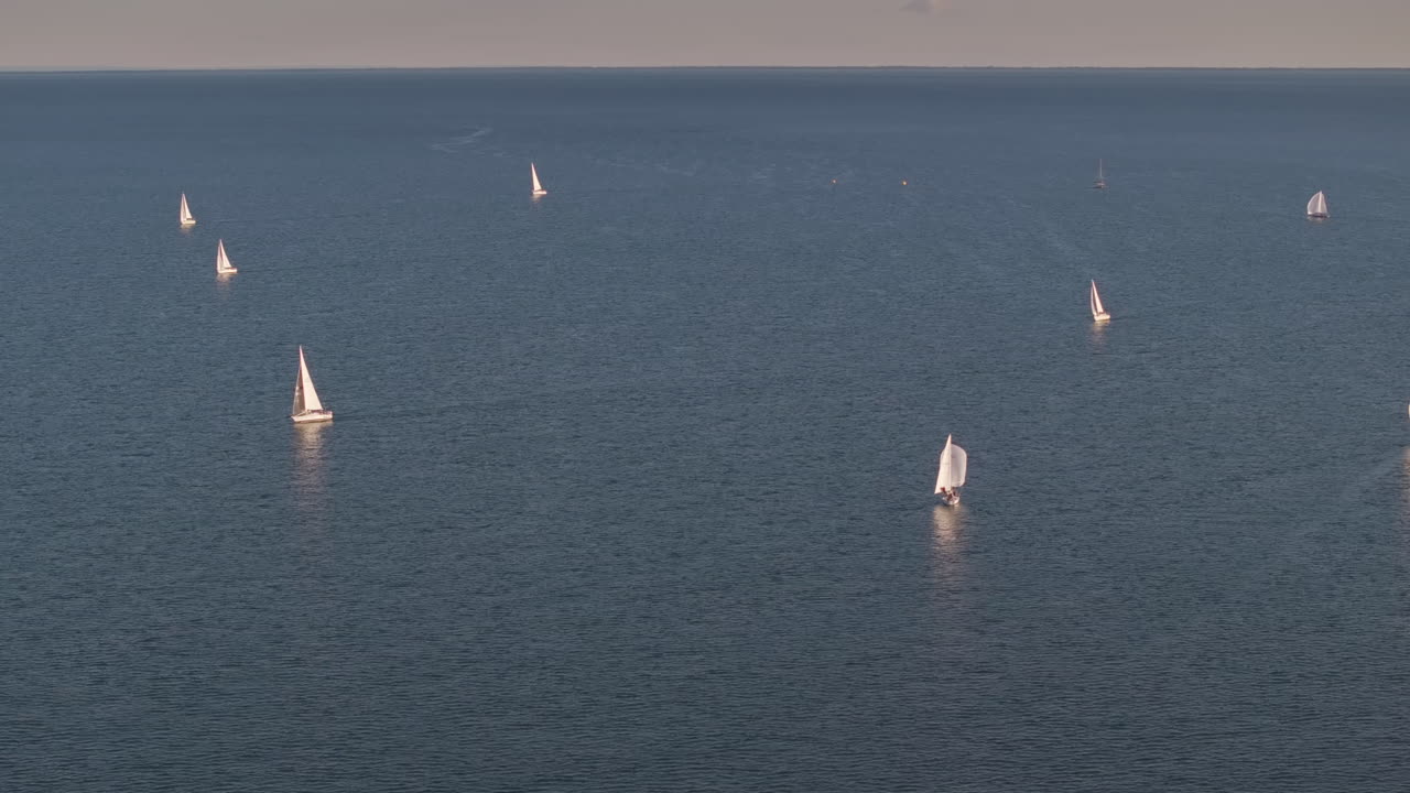 Sailboats gliding on Lake Erie near Port Dover at sunset
