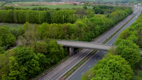 drone ascending to reveal the a2 dual carriage way in canterbury with a bridge crossing over it