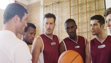 basketball coach assisting players