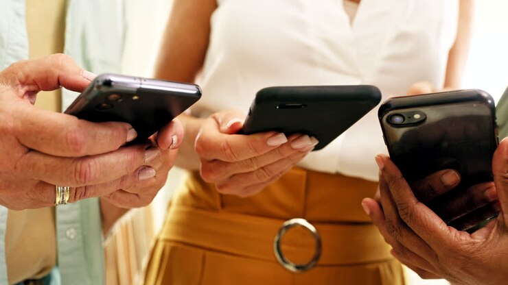 Senior hands, smartphone and friends together