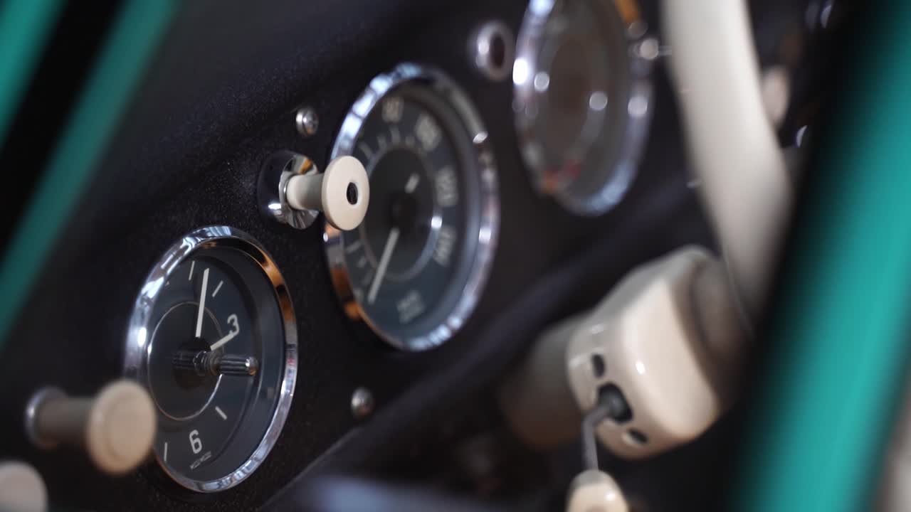 Taro in historic car in dashboard with white steering wheel in wordergrund from old car