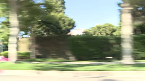 a car travels along a street in century city los angeles as seen through the side window 3