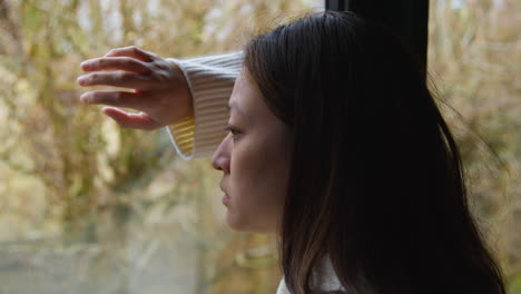 Close-Up-Of-Stressed-Or-Anxious-Woman-Suffering-With-Depression-Anxiety-Loneliness-Or-Agoraphobia-Leaning-Against-Window-At-Home-3