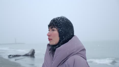 Pretty-Woman-on-the-Beach-on-a-Snowy-Winter-Day---Close-Up-Slow-Motion