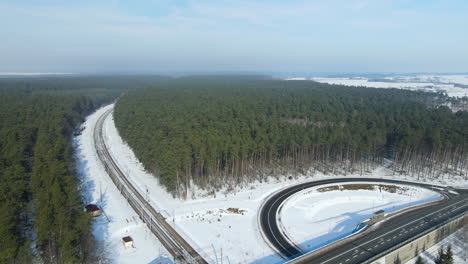 a railroad in a winter forest among coniferous trees