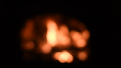 bokeh campfire flame glowing in night darkness