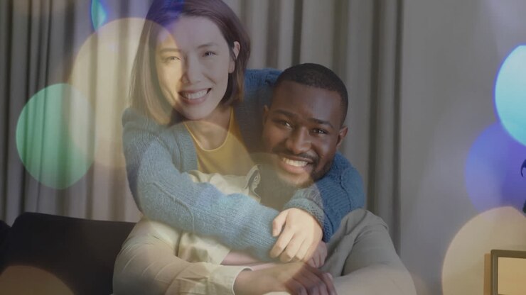 Embracing and smiling, couple with bokeh lights animation in background