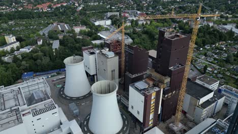 2 crane dismantling a power plant during a demolition process. great aerial view flight drone top down above view
