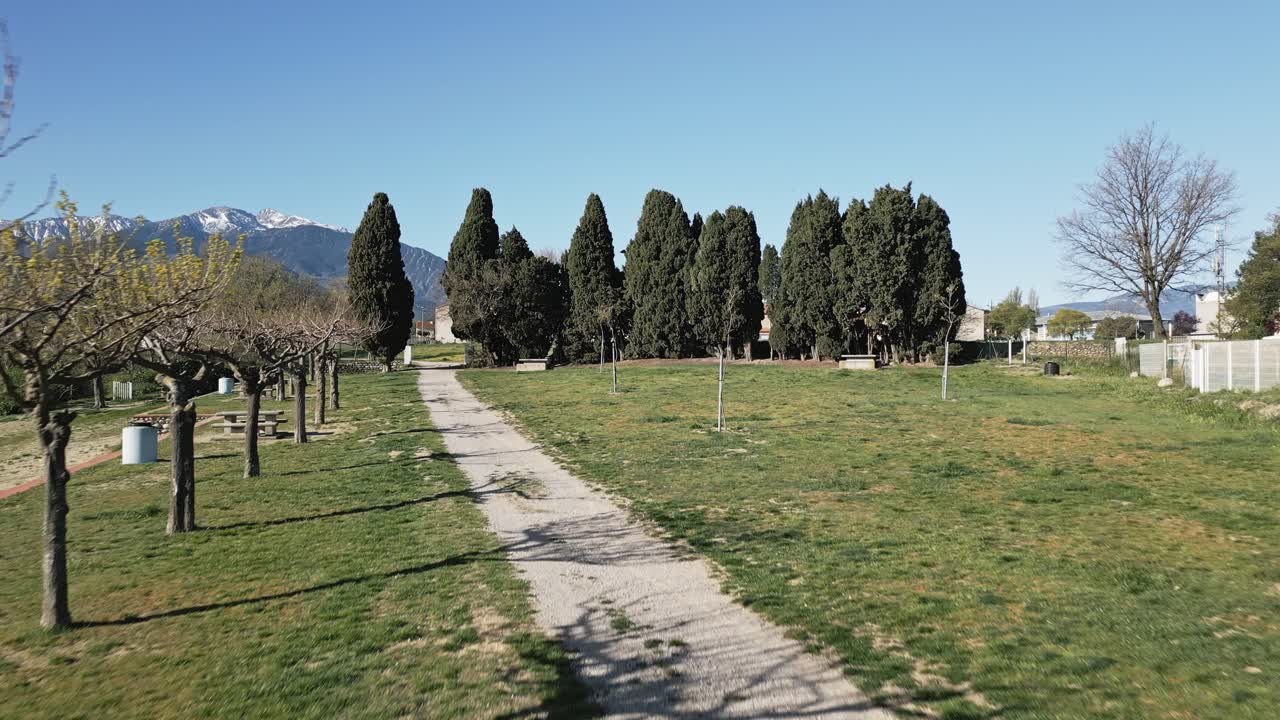 Aerial Drone Fly Low across Lac Vin&ccedil;a Town Landscape France Natural Valley, Cityscape Houses and Pyrenees Mountains