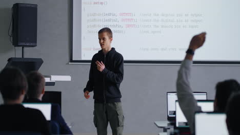 student presenting a coding project in a classroom