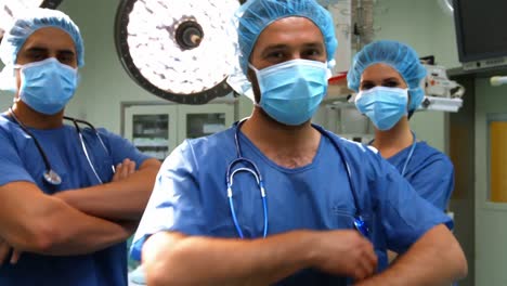 Portrait-of-male-and-female-surgeons-with-arms-crossed-in-operation-room