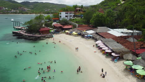 active tropical beach with clear water and mountain